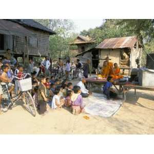  Monks and Villagers Watching Television Outside Farmhouse 