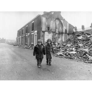  Two Boys Walk Past the Partially Demolished Row of Terrace 