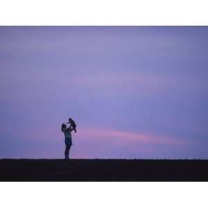  A Mother Holding up Her Baby Sihouetted against a Sky at 