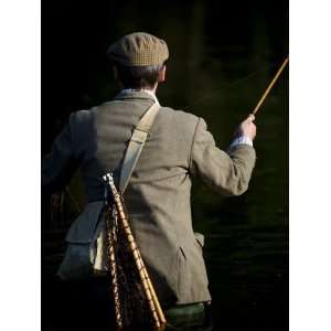 Trout Fisherman Casting to a Fish on the River Dee, Wrexham, Wales 