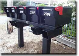 Fortress mailboxes shown on a custom steel rack by Fort Knox Mailbox 
