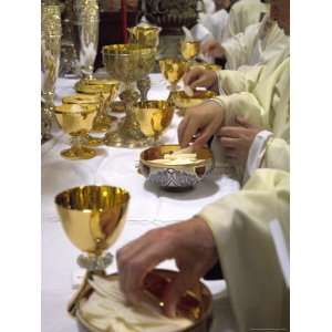  Priests Hands Taking the Host During Mass in Easter Week 